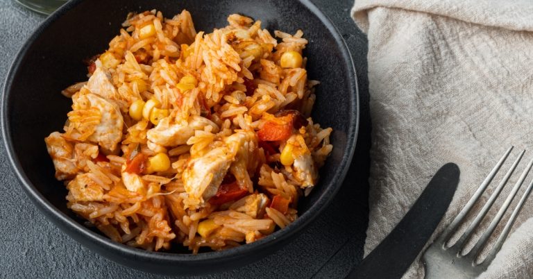 Mexican-Chicken-and-Rice-in-a-Black-Plate-with-Tomato-Sauce.jpg