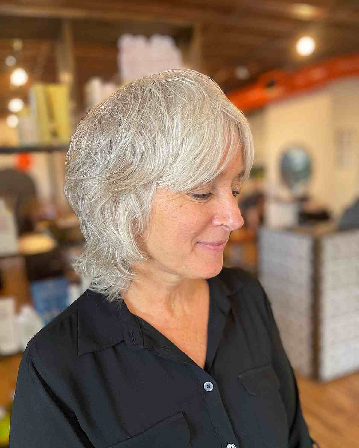 Short Layered Waves with Curtain Bangs on White Hair for a Woman Over 60