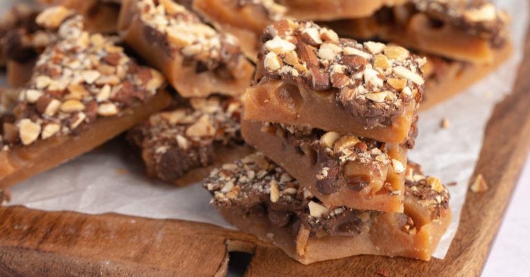 Homemade-Toffee-with-Chocolate-Chips-and-Almond-Nuts-in-a-Wooden-Board.jpg