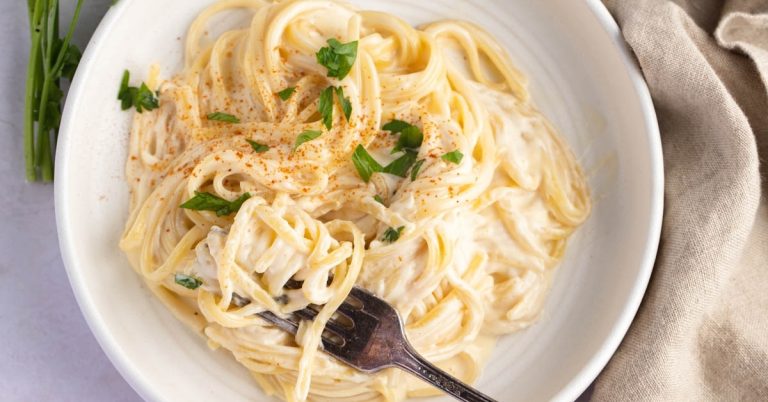 Homemade_Creamy_and_Flavorful_Noodles_Romanoff_with_Herbs_in_a_White_Plate.jpg