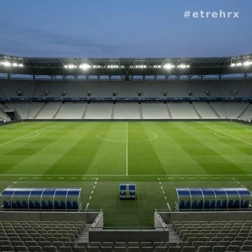 Stade de football vide éclairé en soirée lors d'une grande compétition internationale
